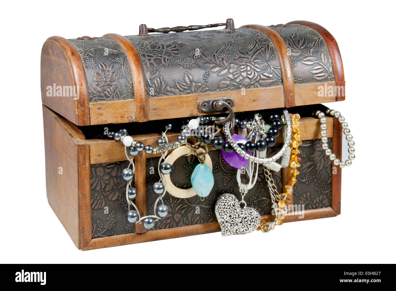 isolated ornamental wooden treasure chest overflowing with jewelry