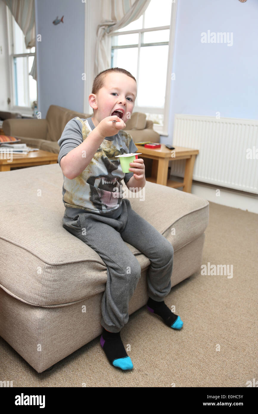 Child eating in front of the TV Stock Photo Alamy