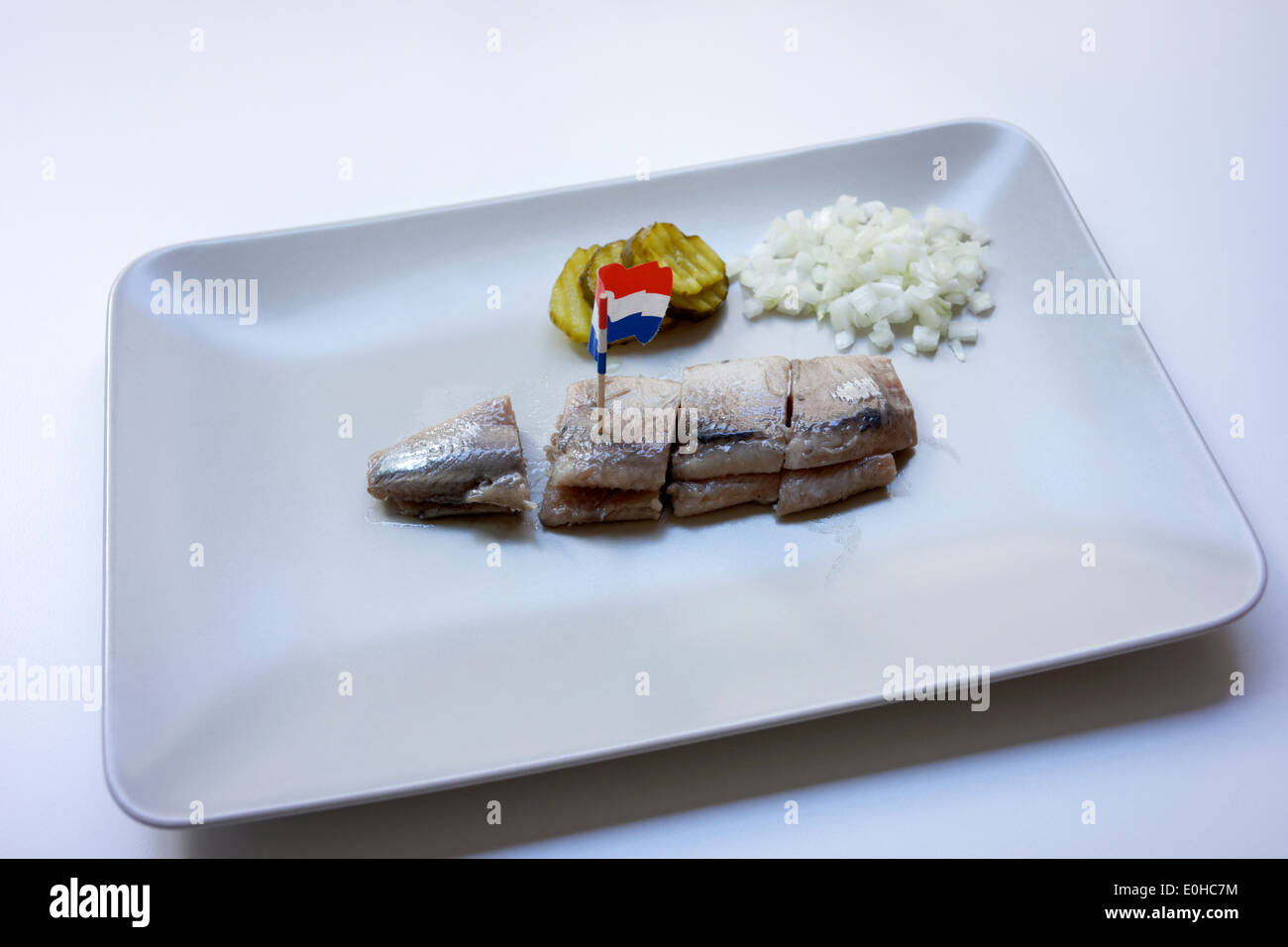 A soused herring, known as Maatjesharing served on a plate in Amsterdam, Holland. Stock Photo