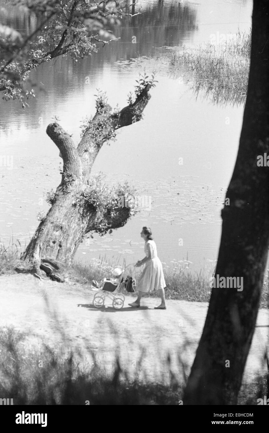 This image captures a summer day in 1963 in the Old Town (Gamlebyen) of Fredrikstad, Norway. It depicts a scene from a stroller tour, showcasing the town's historic architecture and charming streets. Stock Photo