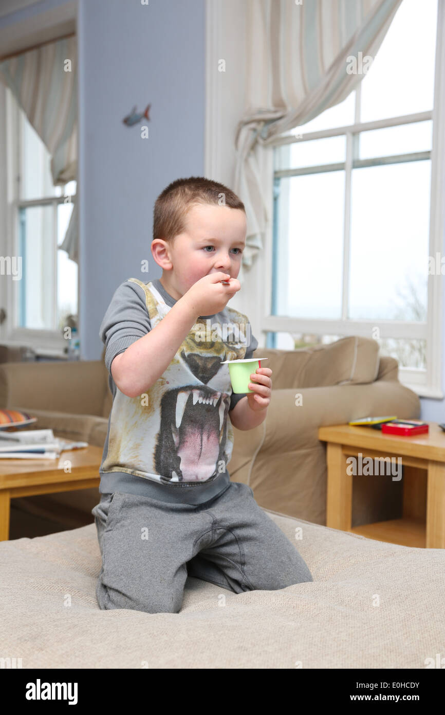 Child eating in front of the TV Stock Photo Alamy
