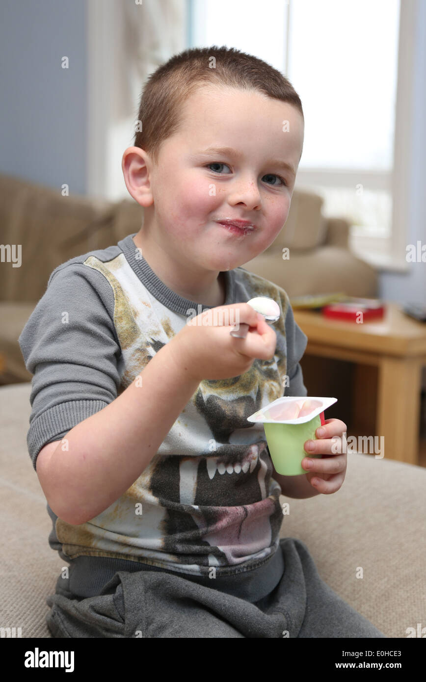 Child eating in front of the TV Stock Photo Alamy