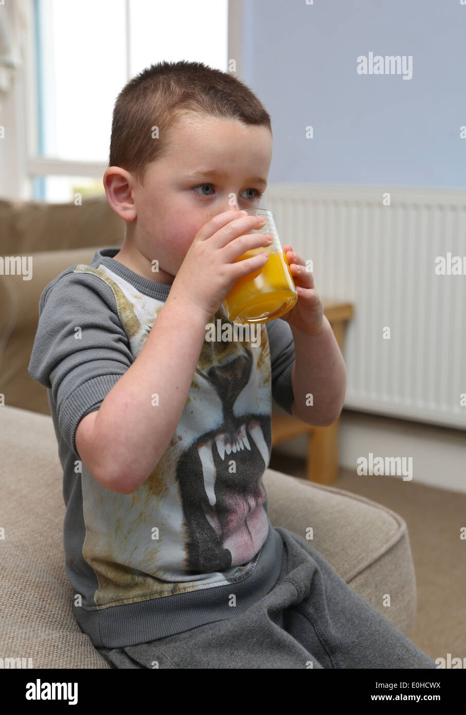 Child eating in front of the TV Stock Photo Alamy