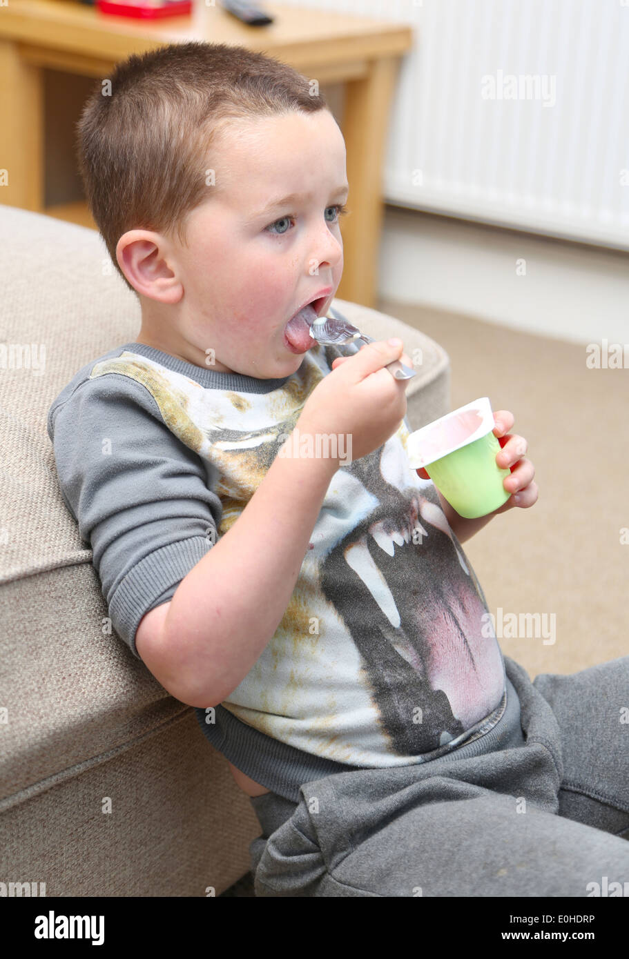 Child eating in front of the TV Stock Photo Alamy