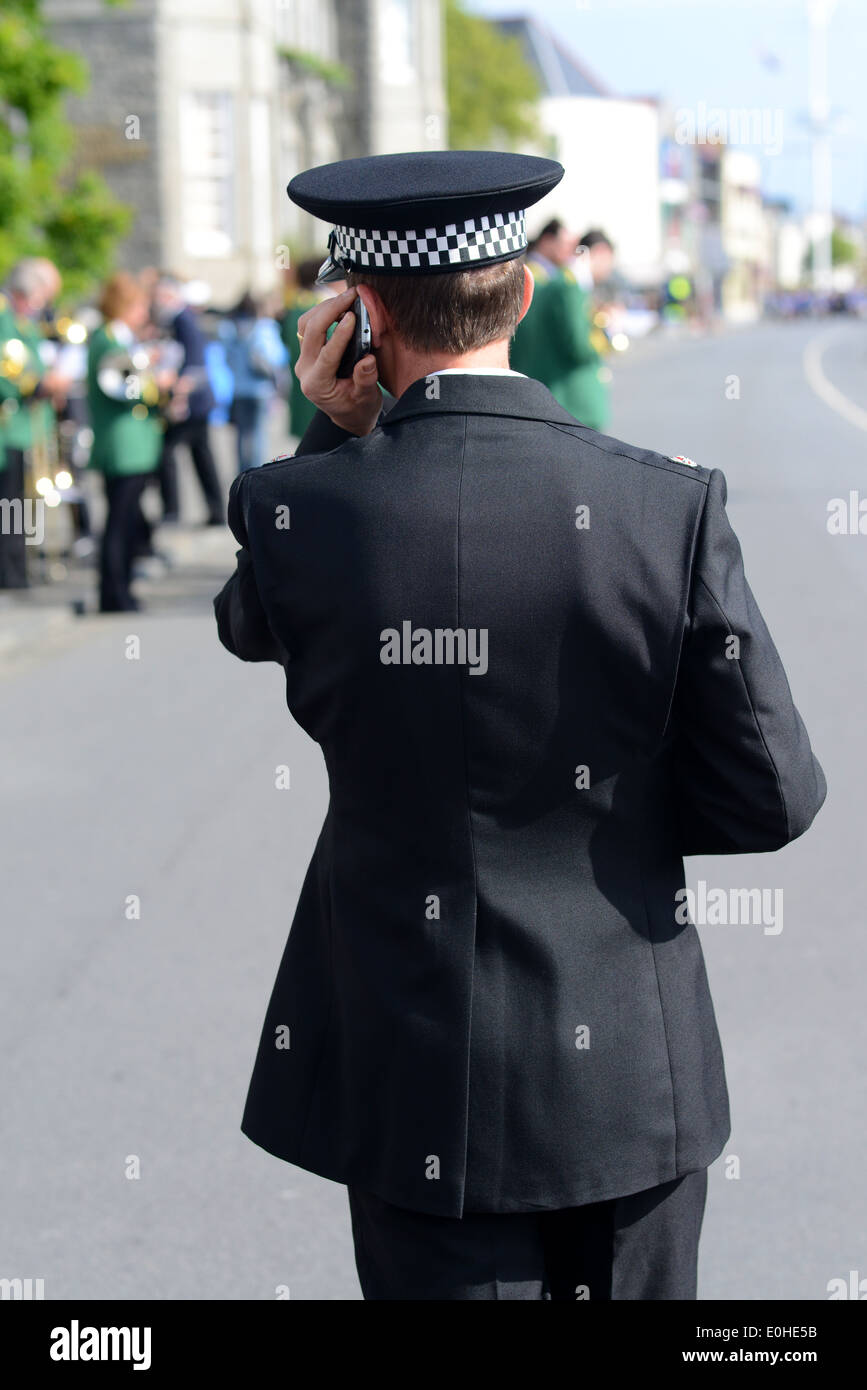 A policeman using a radio Stock Photo