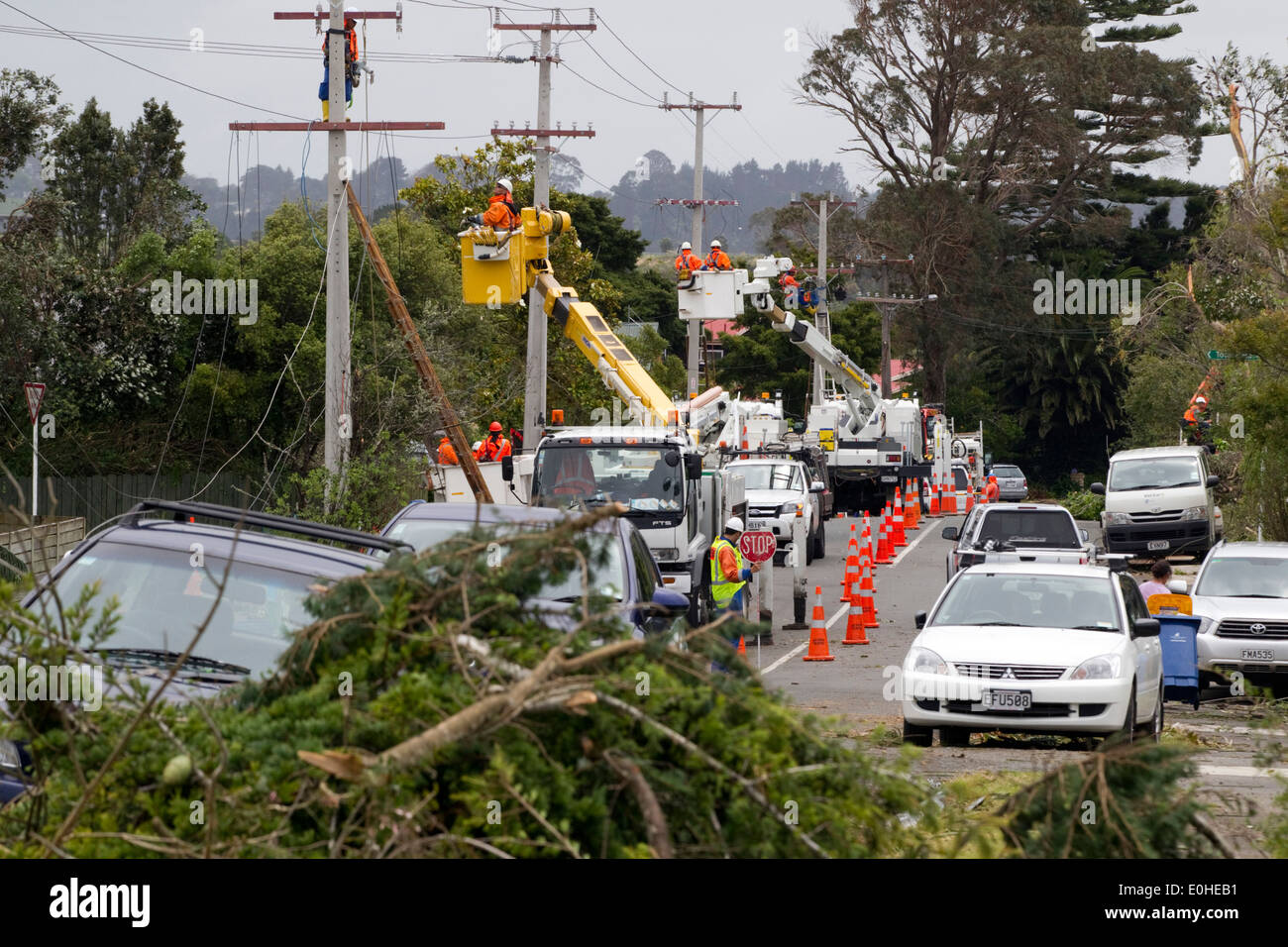 Power workers, part of the clean up operation at the scene of devastation following a Tornado, Waimarie Road, Whenuapai, Aucklan Stock Photo