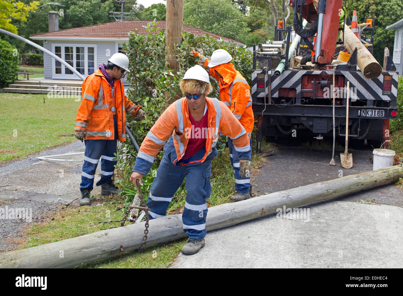 Power workers, part of the clean up operation at the scene of devastation following a Tornado, Waimarie Road, Whenuapai, Aucklan Stock Photo