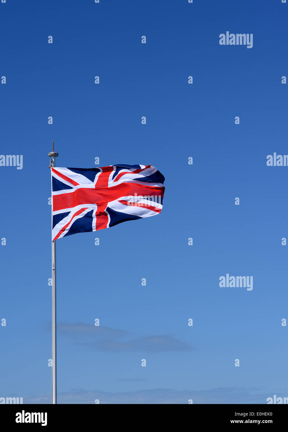 The Union Jack flag against a blue sky Stock Photo - Alamy