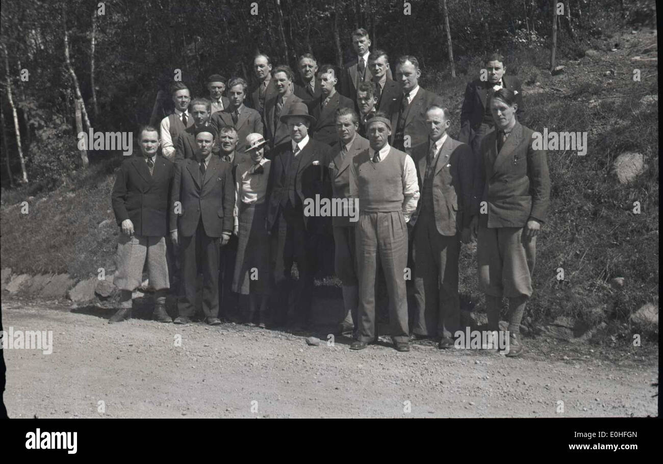 A photograph of Vidkun Quisling with a group of men dressed in civilian clothing, likely associated with the National Socialist (NS) movement in Norway during the 1930s. The image offers a glimpse into the political landscape of Norway before World War II. Stock Photo