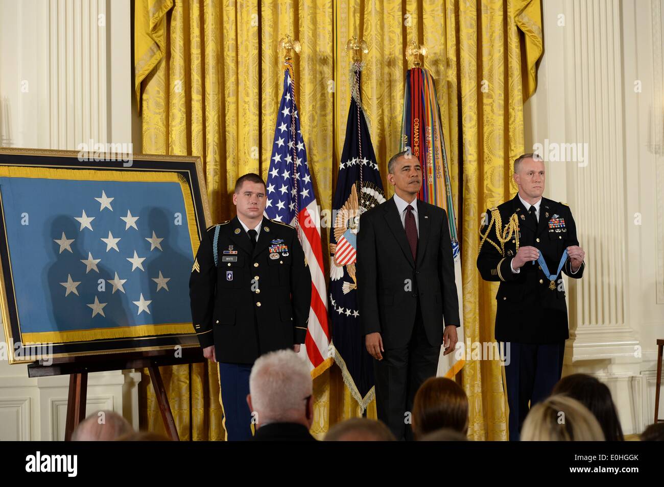 US President Barack Obama and former Army Sergeant Kyle White listen to ...