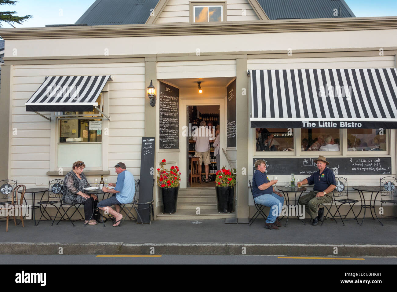 Akaroa New Zealand The Little Bistro best French restaurant at night with cruise ship passengers dining alfresco drinking wine Stock Photo
