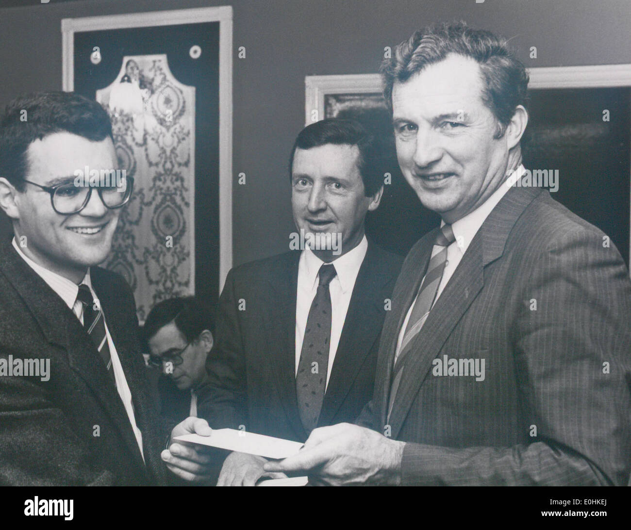 Peter Davern, U.L. (left), receives the FICI bursary from Michael Smith, TD, Minister for Science and Technology, with Michael Granville, President, FICI, 7 May 1990. Stock Photo