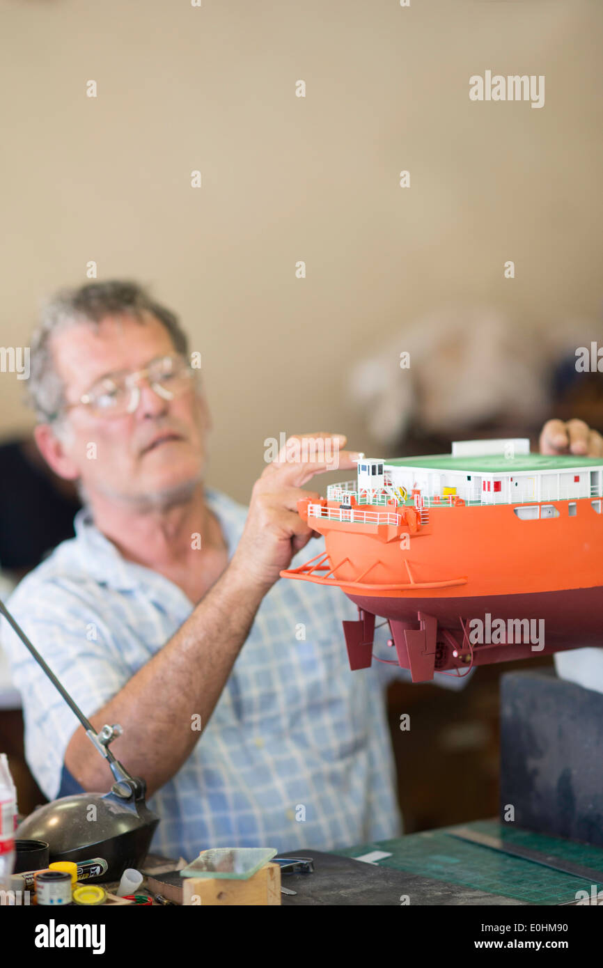Man handcrafting a model of the DeBeers Diamond Mining ship operating off the coast of Namibia, Model Ship Builder, South Africa Stock Photo
