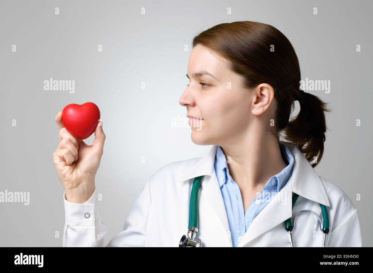 Red heart shape in the hand of a doctor Stock Photo