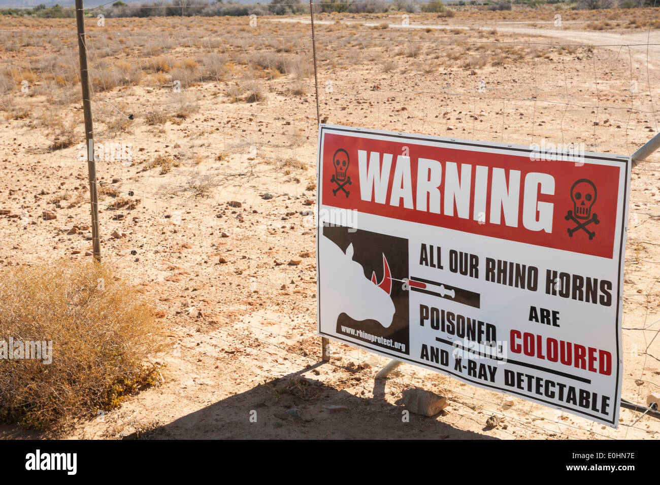 Warning sign for poachers about rhino horns at Inverdoorn Game Reserve, Ceres, Karoo district, South Africa Stock Photo
