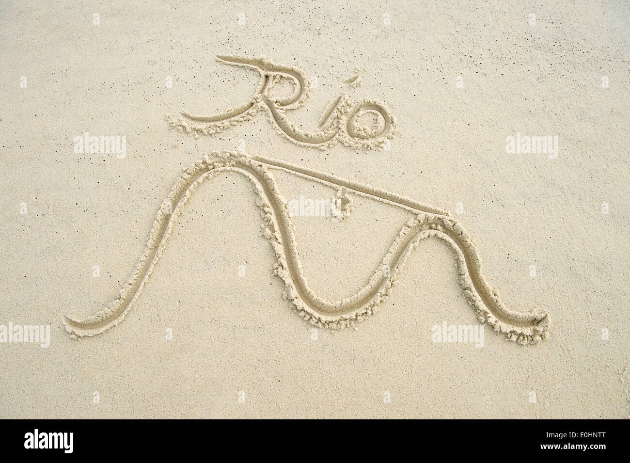 Rio de Janeiro message on sand beach with iconic shape of Sugarloaf Mountain Brazil Stock Photo