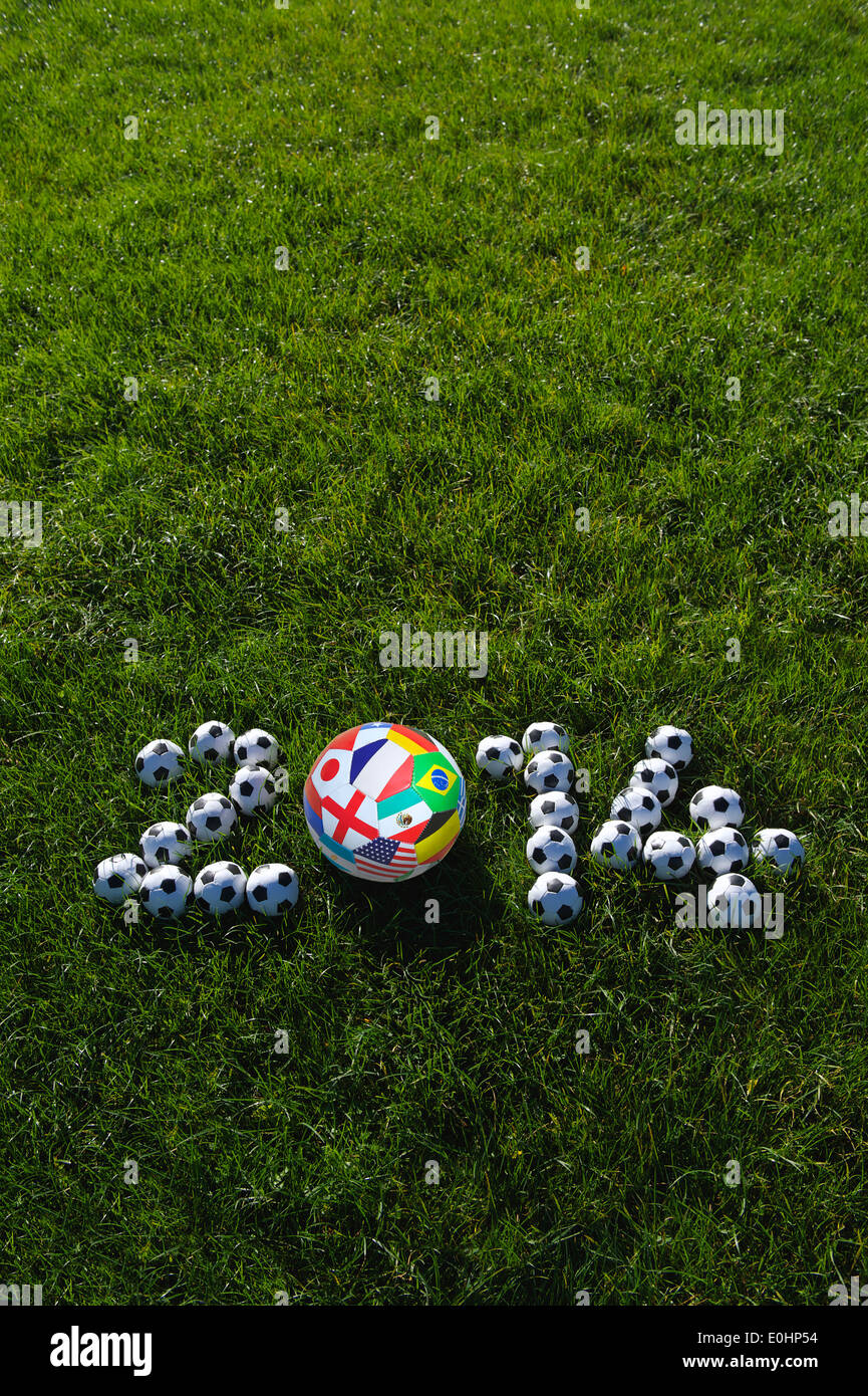 Message for 2014 featuring international teams football soccer balls in green grass field Stock Photo