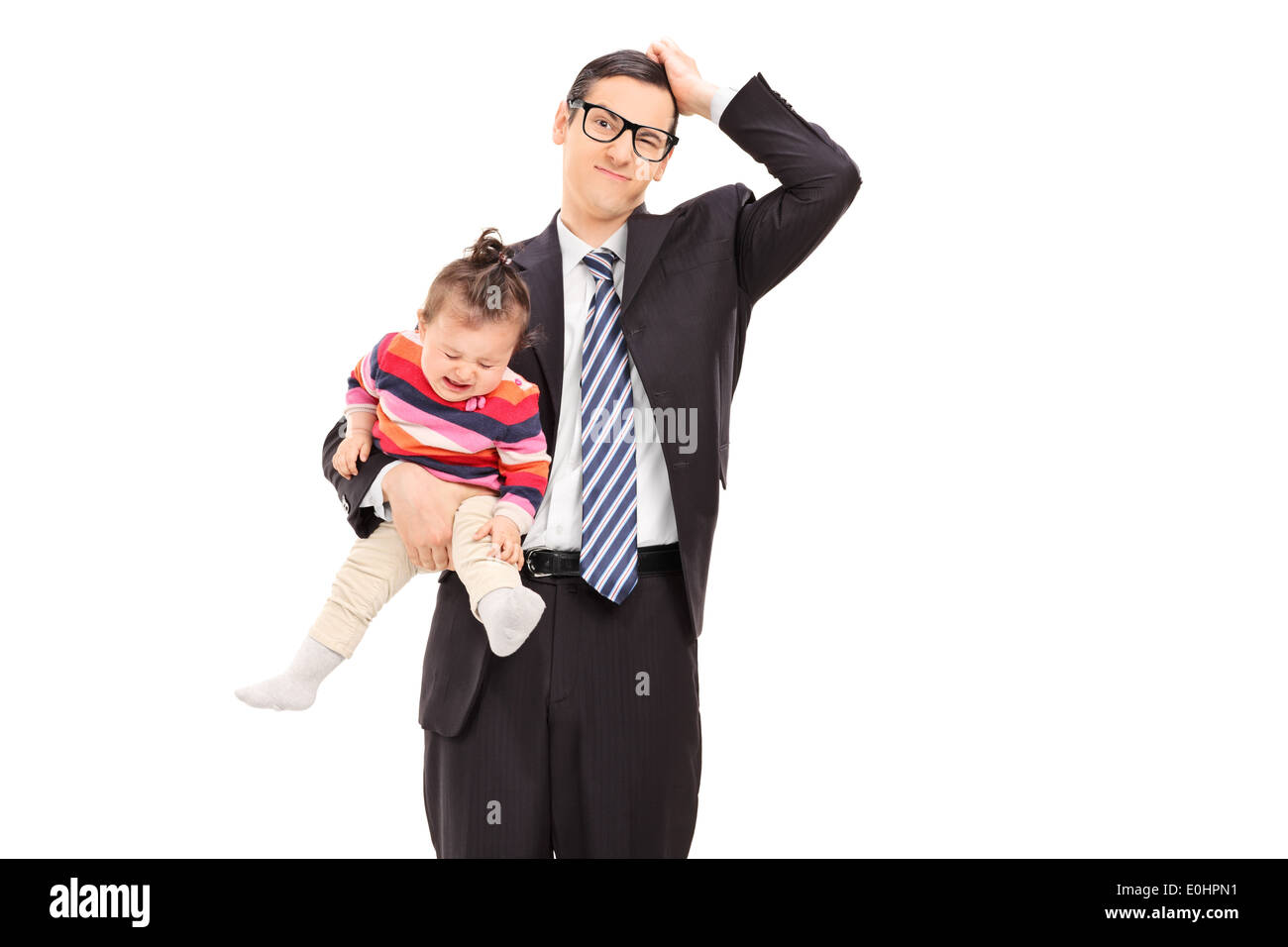 Confused businessman holding a crying baby Stock Photo
