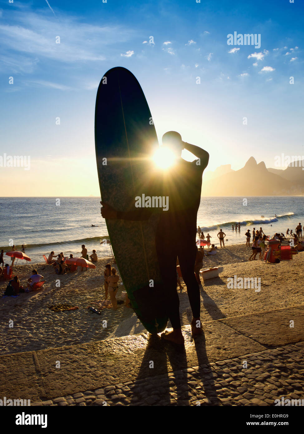Sunset silhouette of longboard surfboard at Arpoador Ipanema Beach Rio