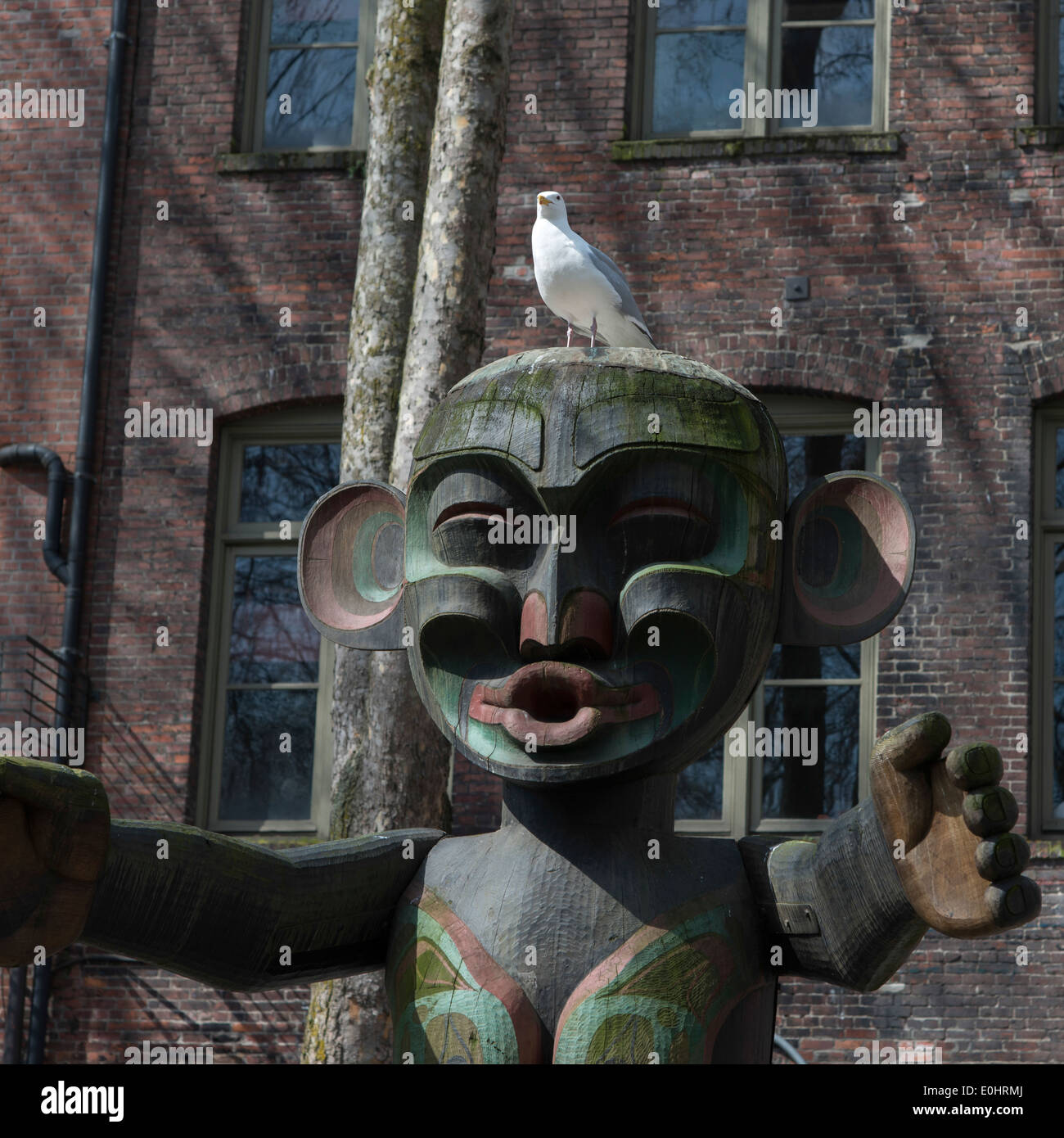 Totem pole in front of a building, Occidental Park, Pioneer Square, Seattle, Washington State, USA Stock Photo