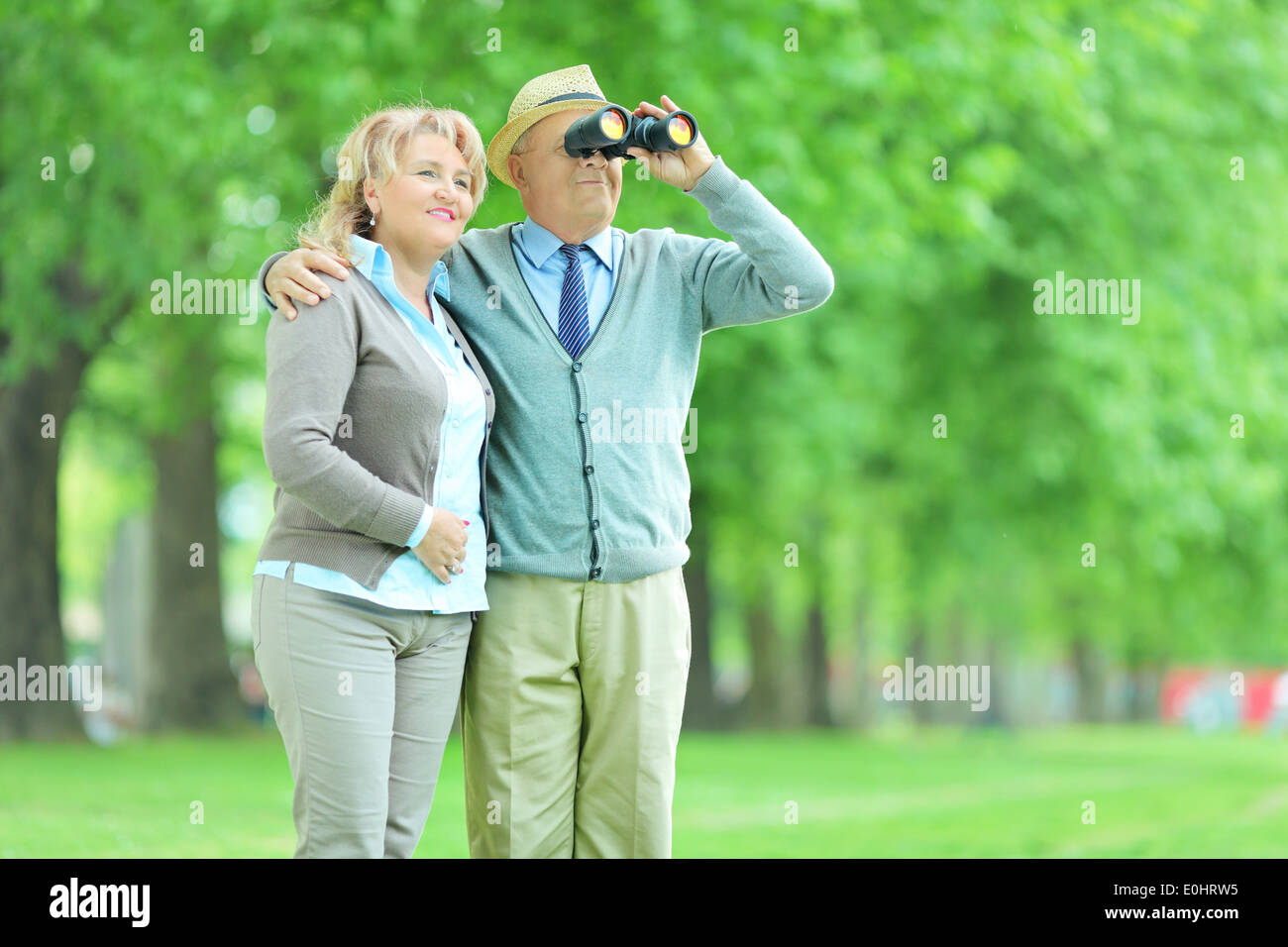 Senior couple looking through binoculars outdoors Stock Photo Alamy