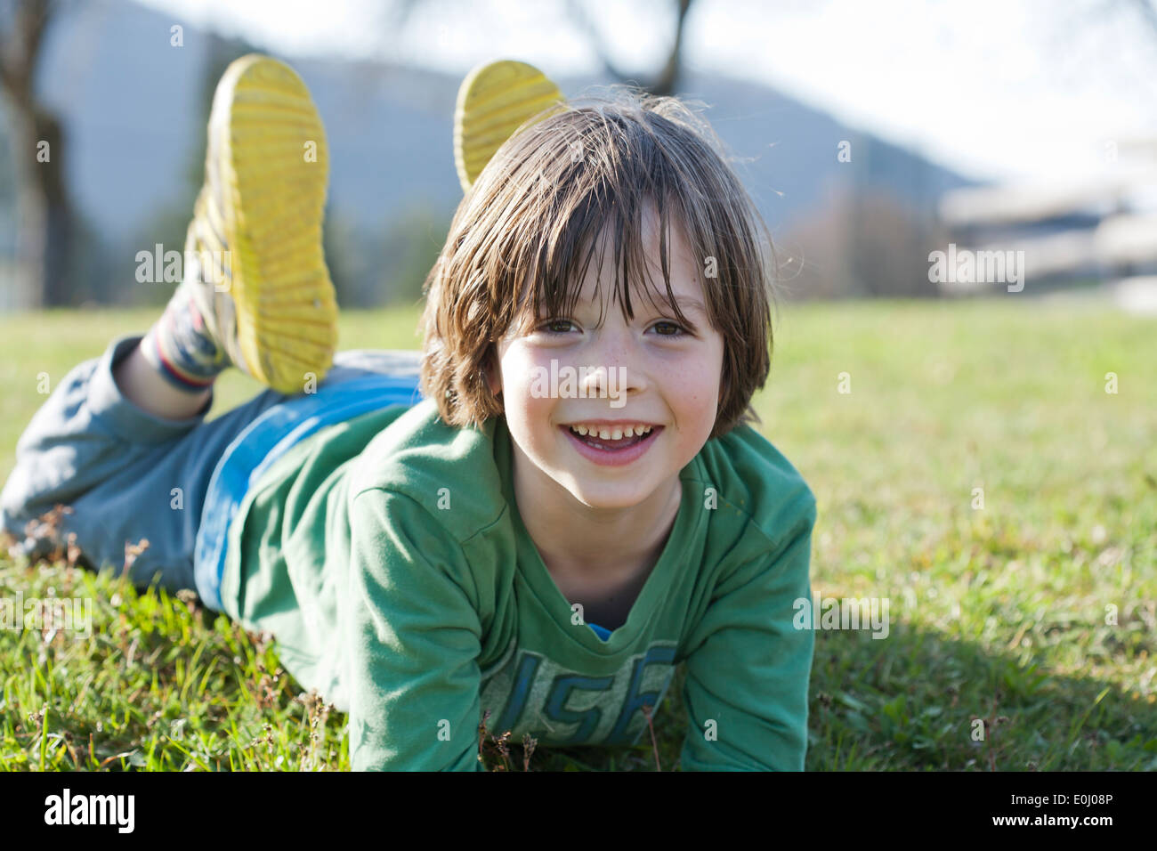 Boy lying on lawn Stock Photo - Alamy