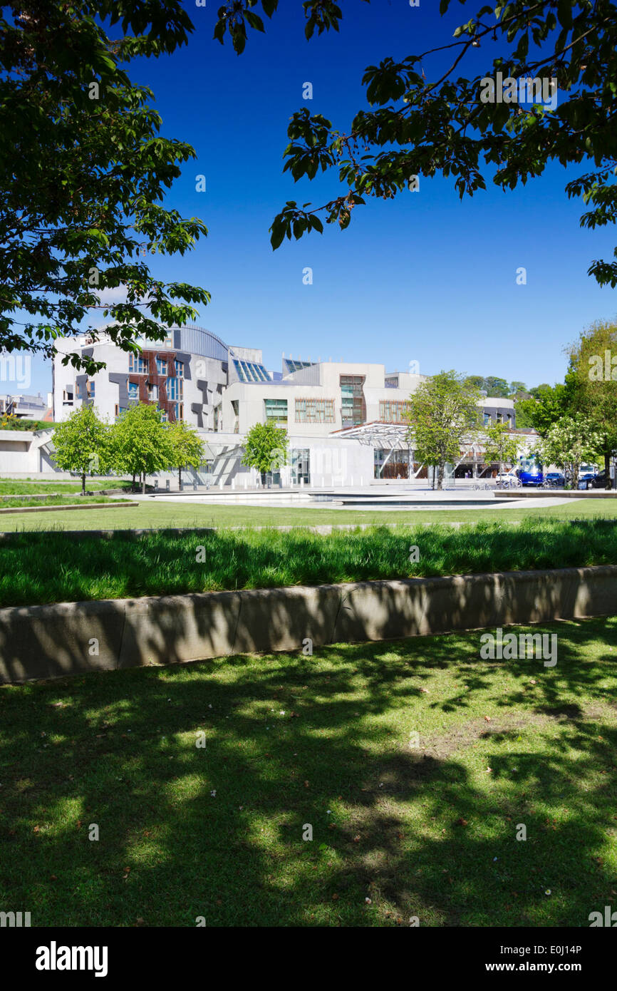 Scottish Parliament Building With Blue Sky And Green Foliage On Trees Stock Photo