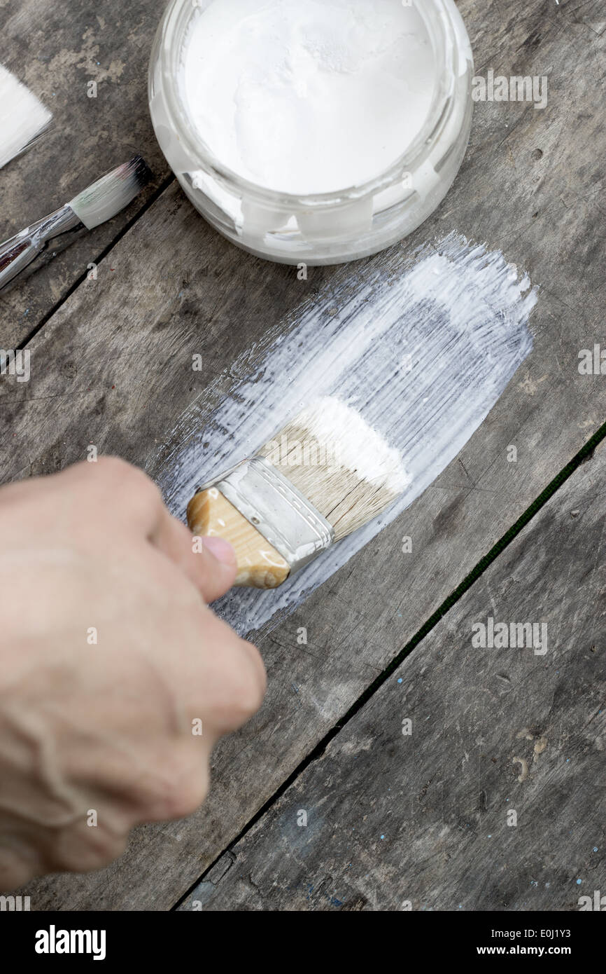 Brush painting wooden furniture, close up Stock Photo Alamy