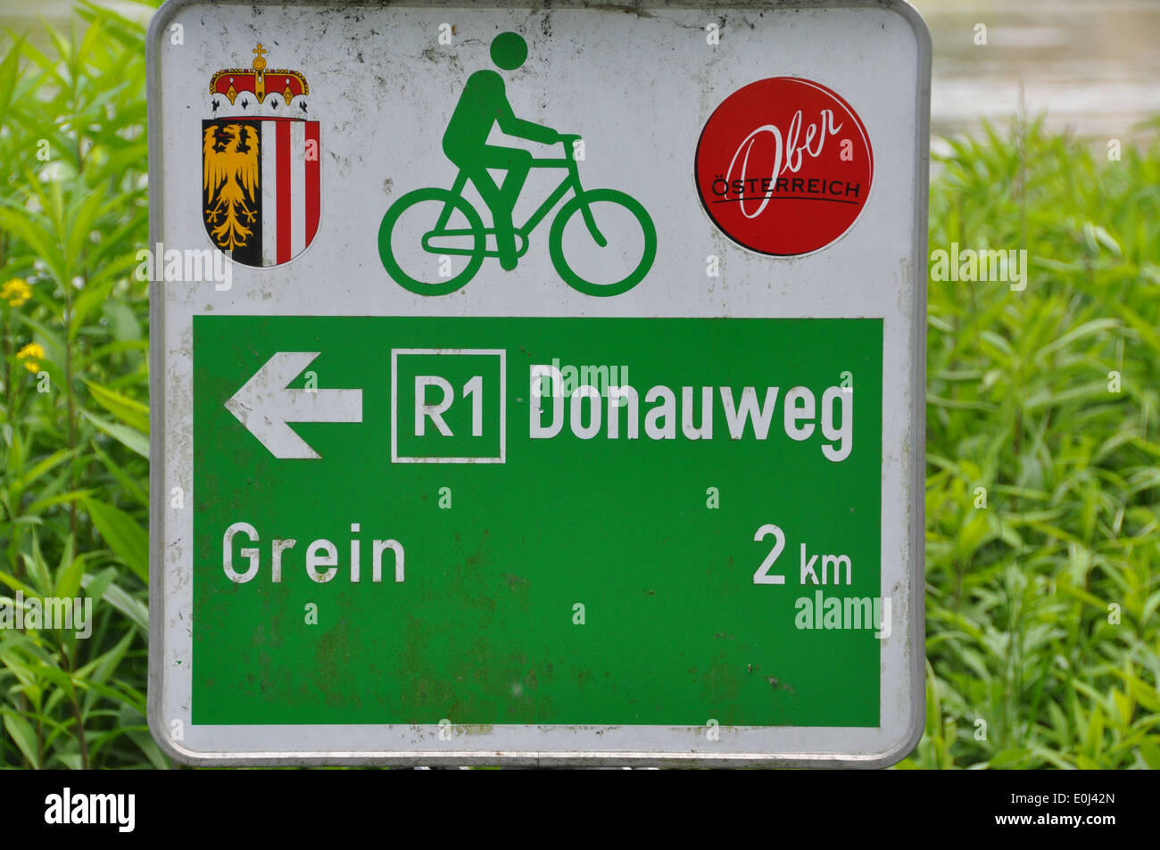 Bike sign indicating Donauweg route 1, and direction to Grein. Stock Photo