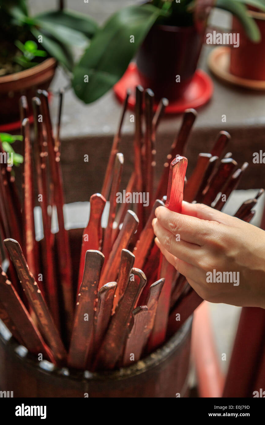 Hand of a woman picking fortune telling sticks Stock Photo Alamy