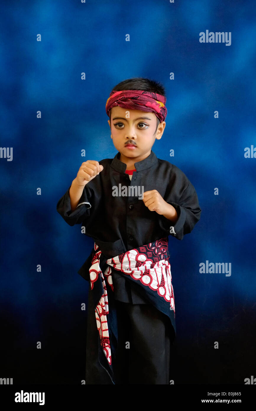 little boy poses in fancy dress at school to commemorate the indonesian