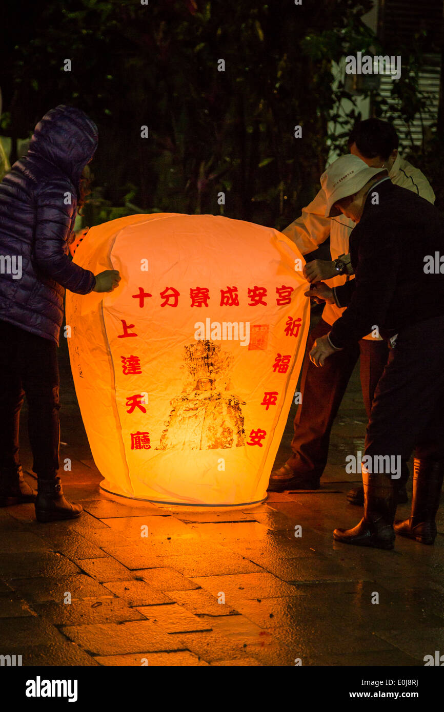 People preparing big lantern to float Stock Photo