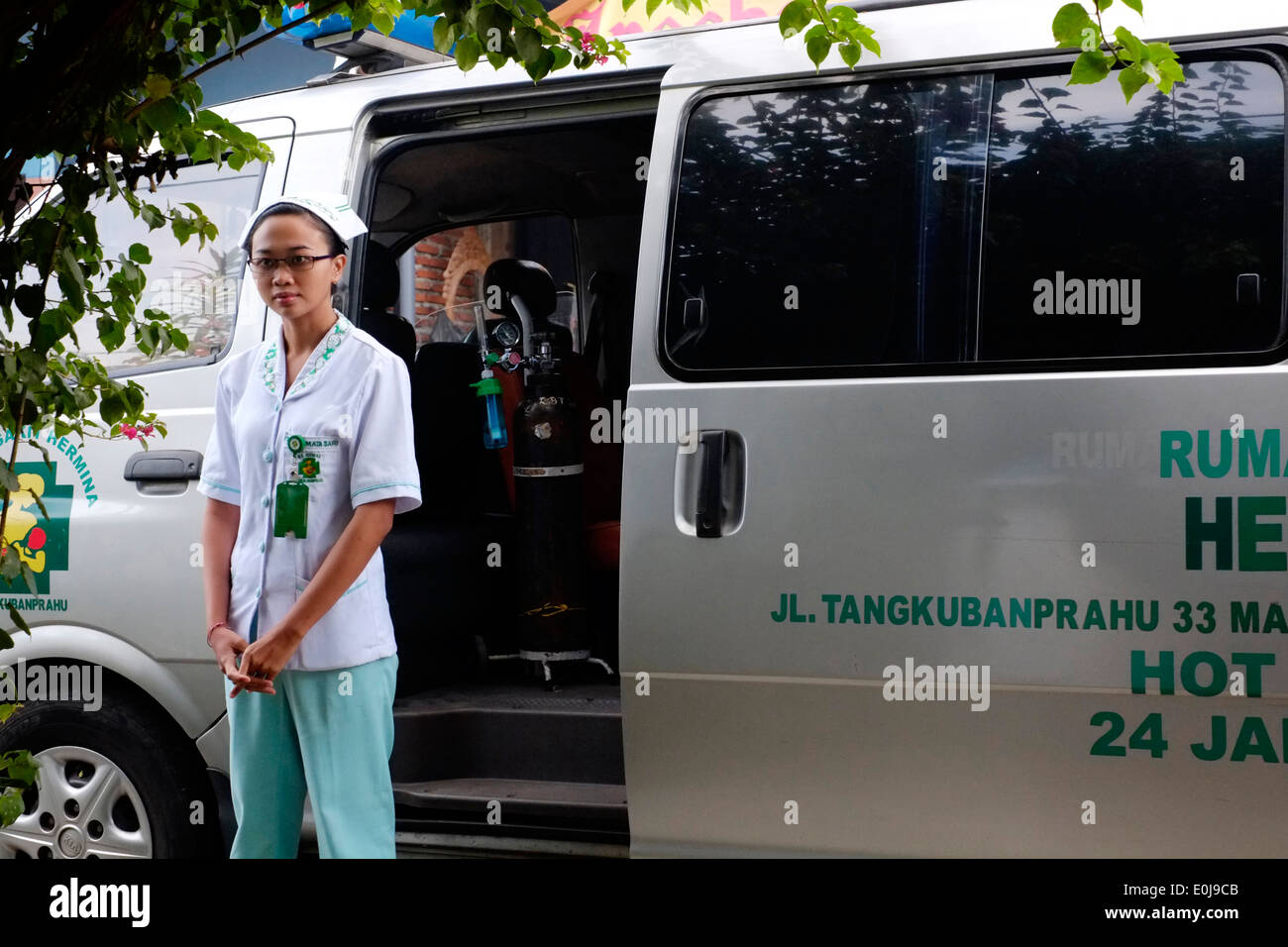 indonesian nurse waiting by ambulance for patient prior to her cesarean c section operation in malang east java indonesia Stock Photo