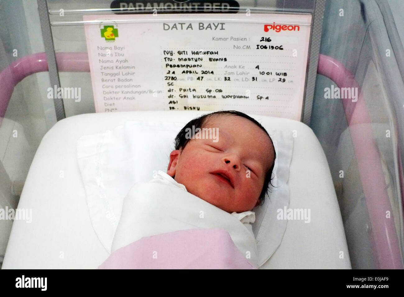 newborn baby a few hours old laying in hospital cot in malang indonesia Stock Photo