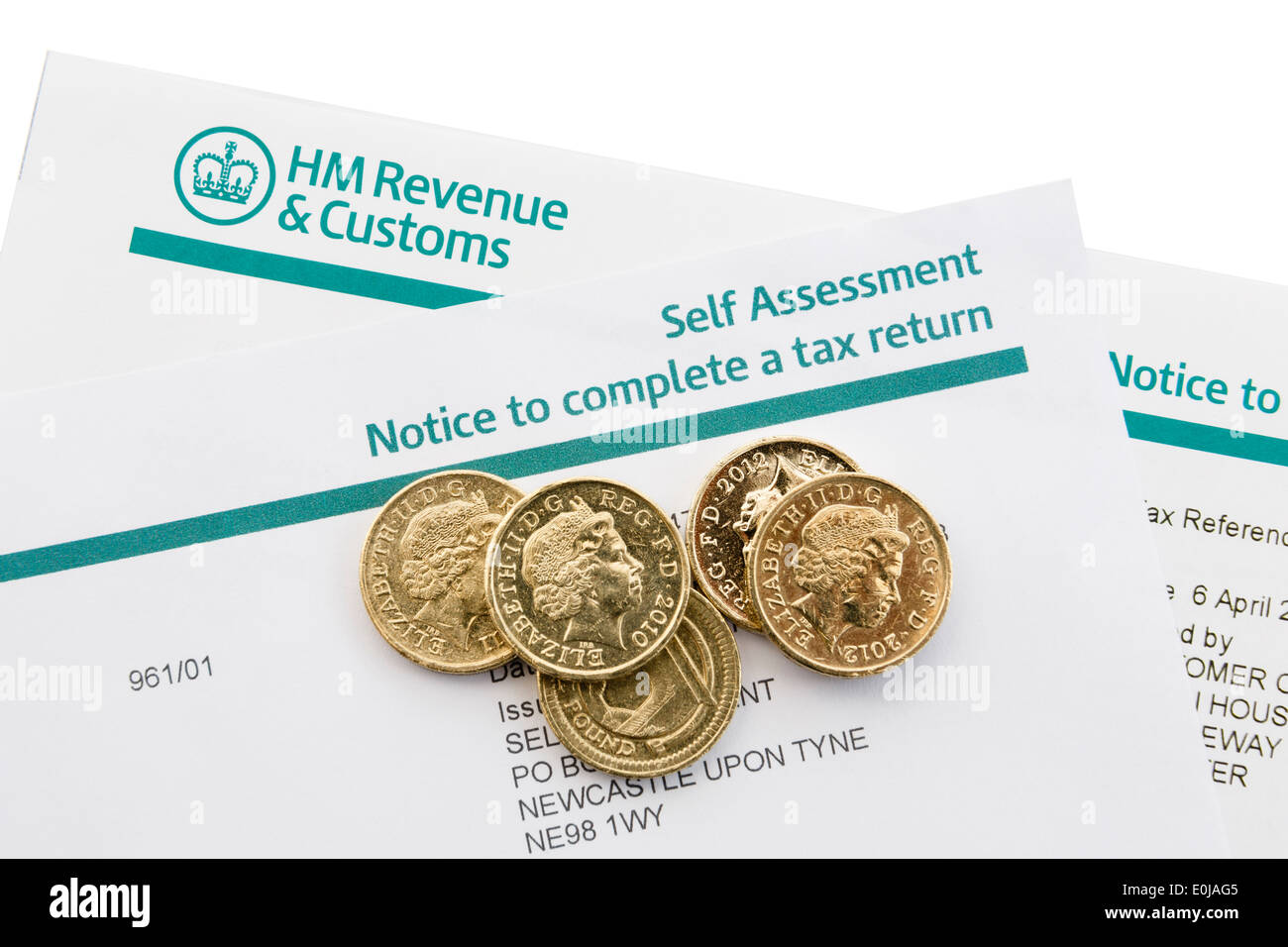 UK HM Revenue & Customs Self Assessment Notice to complete a tax return with some pound coins on white. England Britain Stock Photo