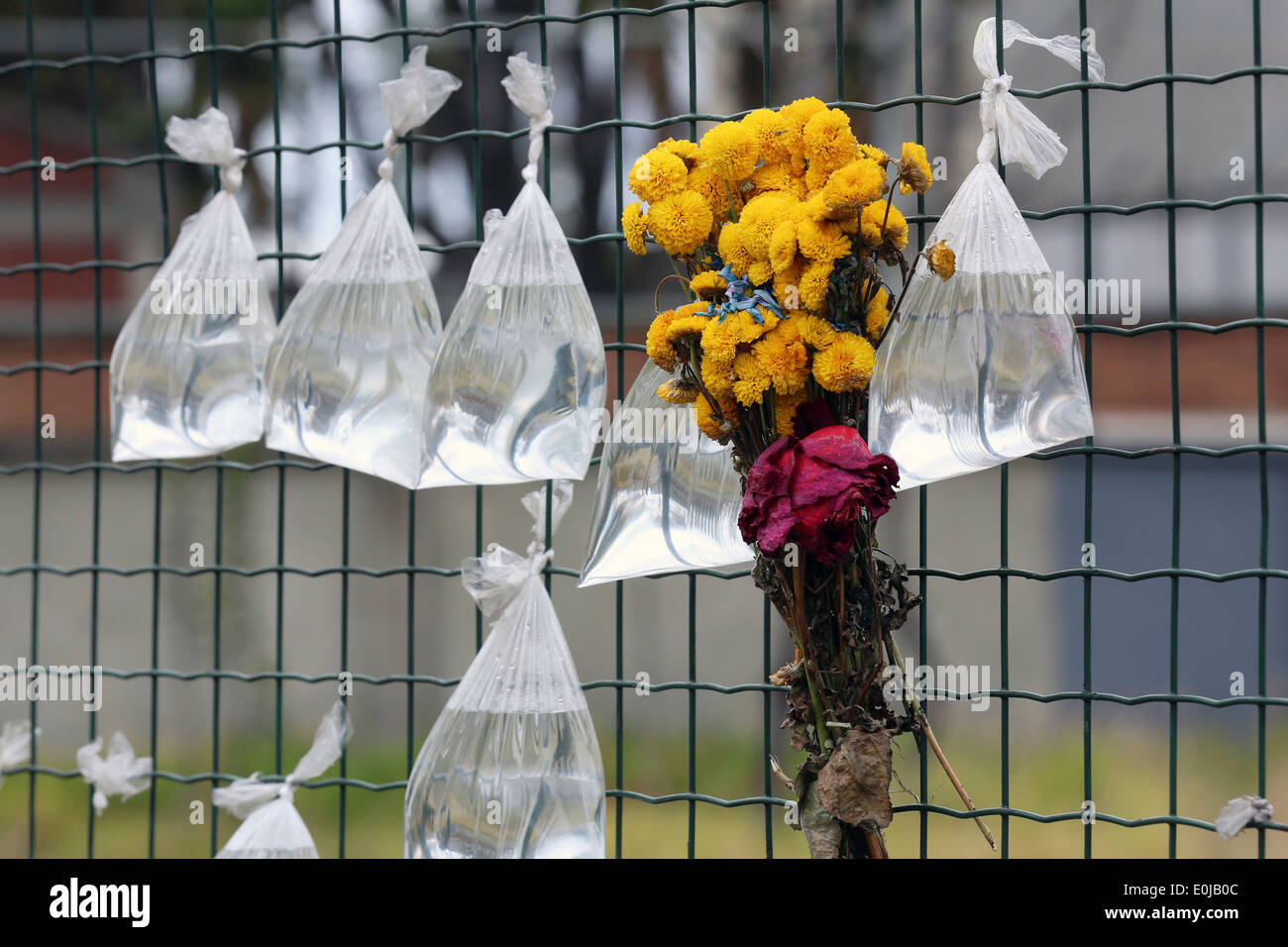 Tansparent plastic bags with water on a fence of the churchyard of nameless dead persons. Bogota, Colombia, South America Stock Photo