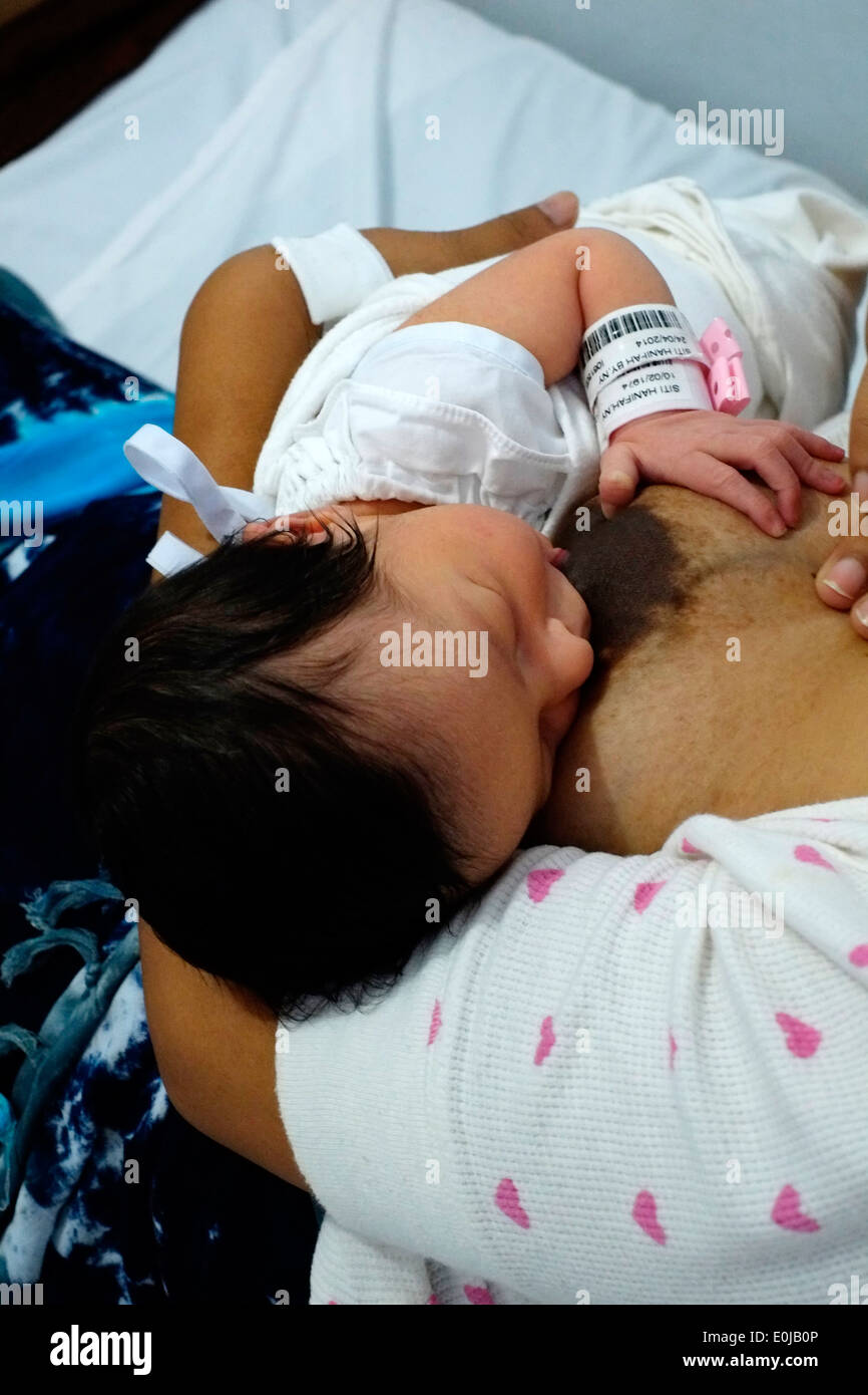 indonesian woman breast feeds her newborn daughter for the first time soon  after birth in hospital malang java indonesia Stock Photo - Alamy
