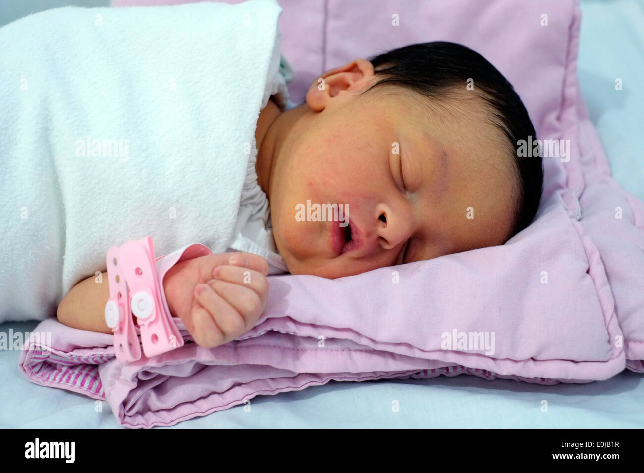 newborn baby a few days old laying in hospital cot in malang east java indonesia Stock Photo