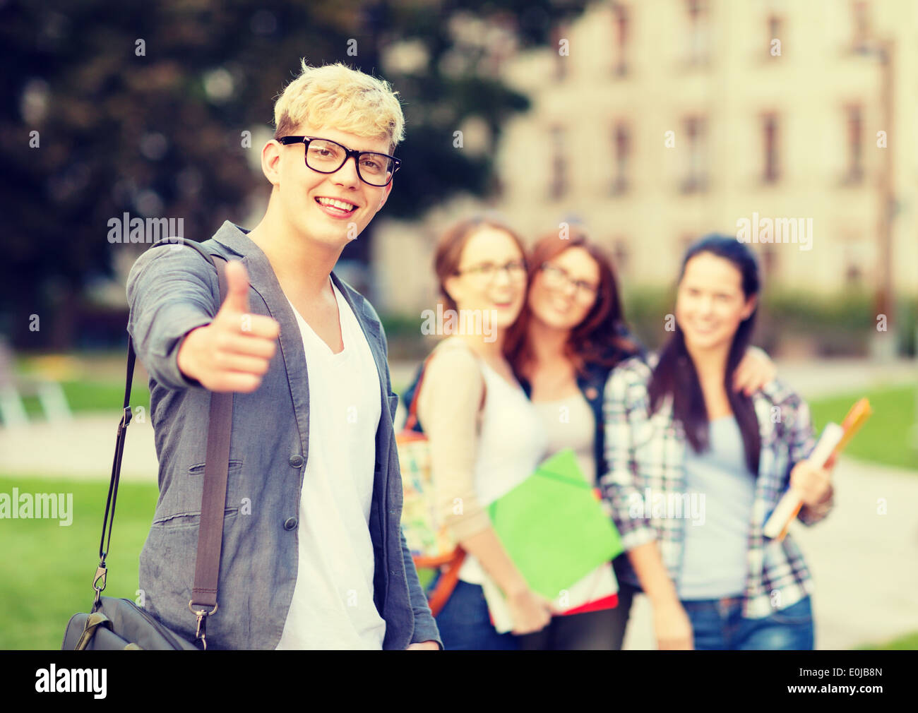 male student in eyglasses showing thumbs up Stock Photo - Alamy