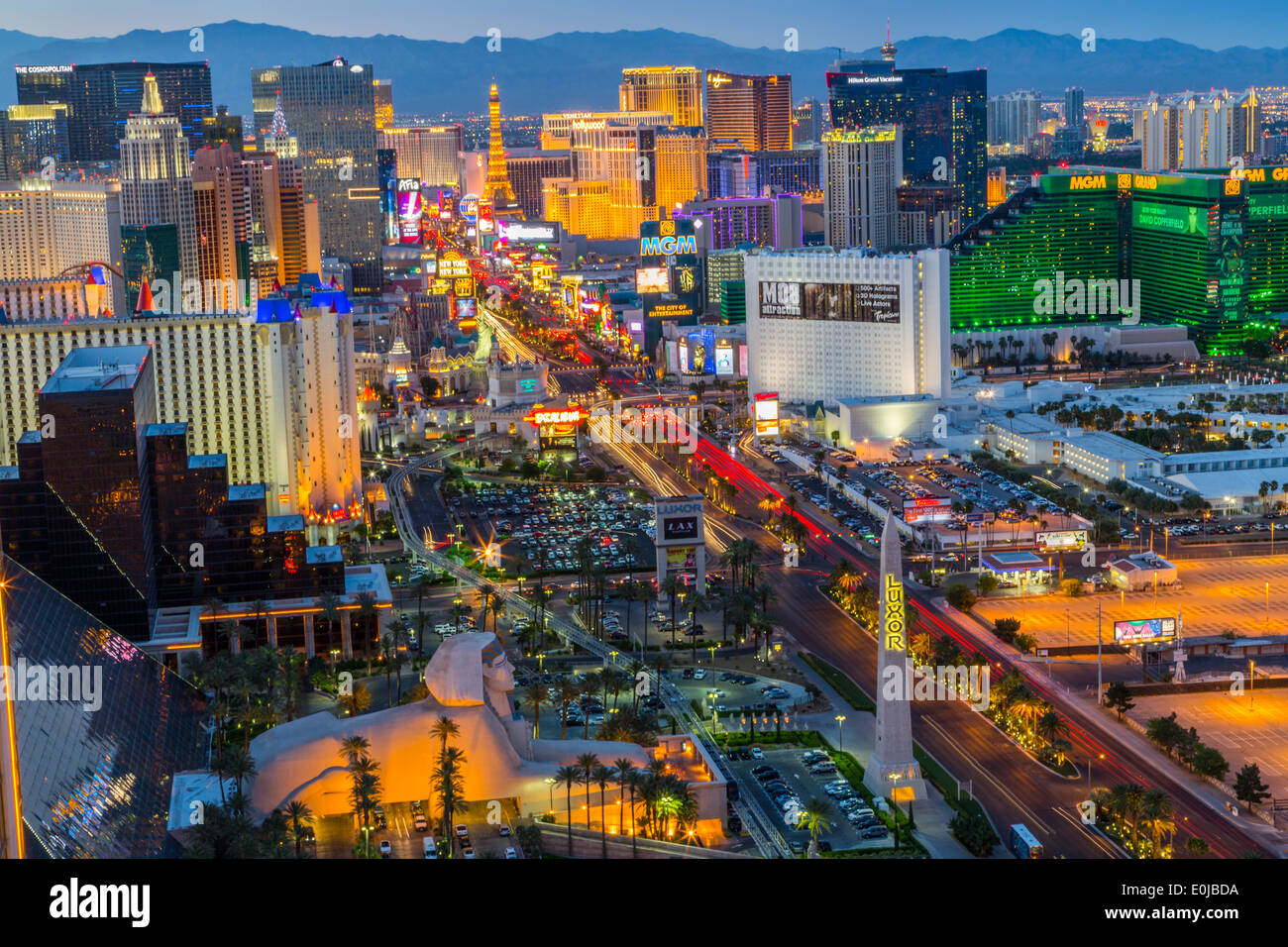 An elevated panoramic landscape view of The Las Vegas strip at dusk with the Luxor Hotel in the 