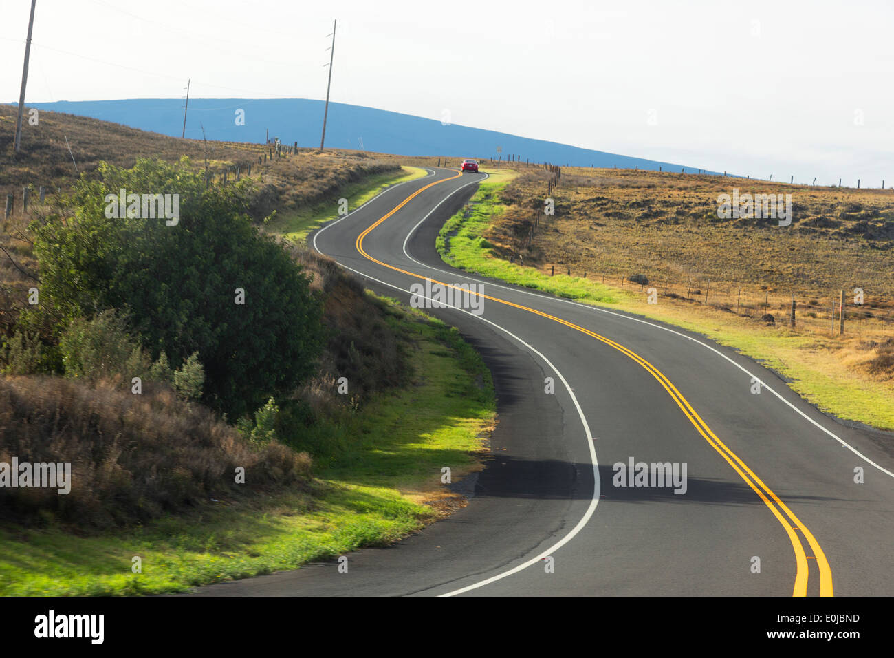 Red car on winding Saddle Road with Mauna Kea in background Big Island, Hawaii Stock Photo Alamy