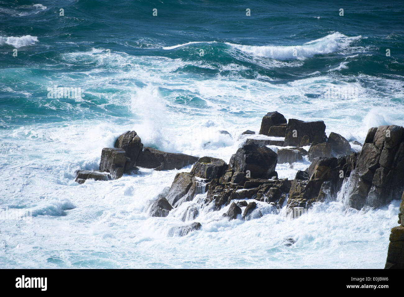 Waves breaking on rocks at Land's End in Cornwall, England. Stock Photo