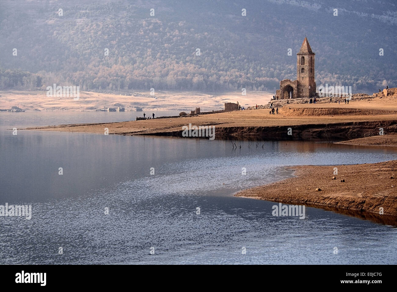 Medieval church of Sant Roma de Sau emerged from the Sau reservoir during a period of drought in Catalonia. Stock Photo