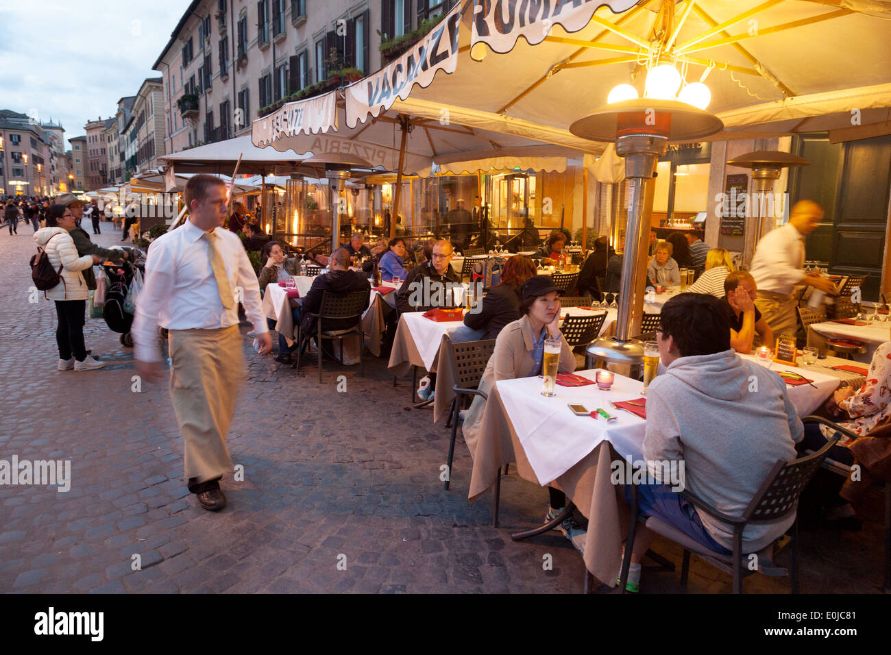 People eating at a restaurant in the early evening, Piazza Navona, Rome, Italy Europe Stock Photo