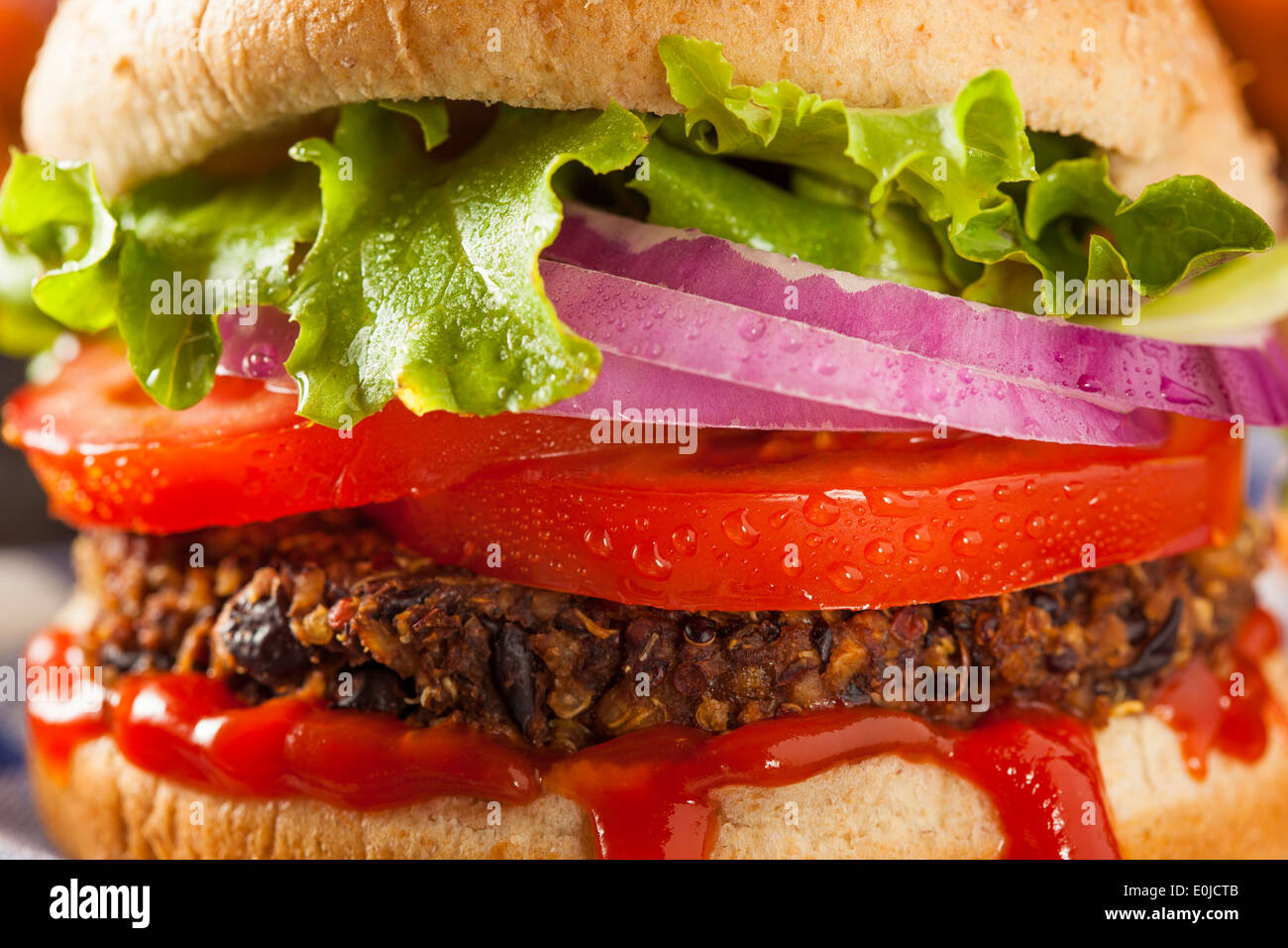 Homemade Healthy Vegetarian Quinoa Burger with Lettuce and Tomato Stock Photo