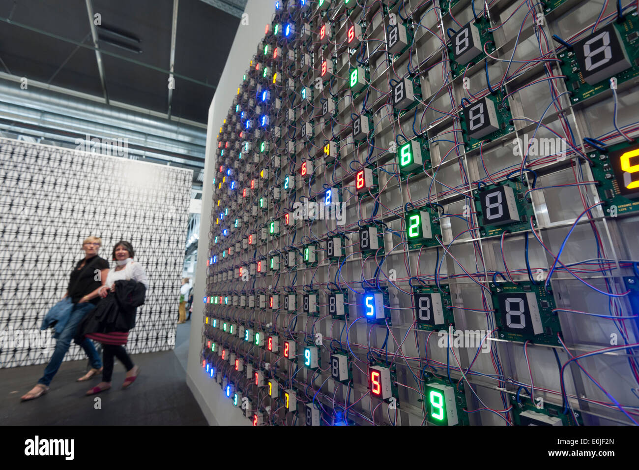 Visitors are passing by an artwork exhibited at the Art Basel 2013 in Basel, Switzerland. Stock Photo