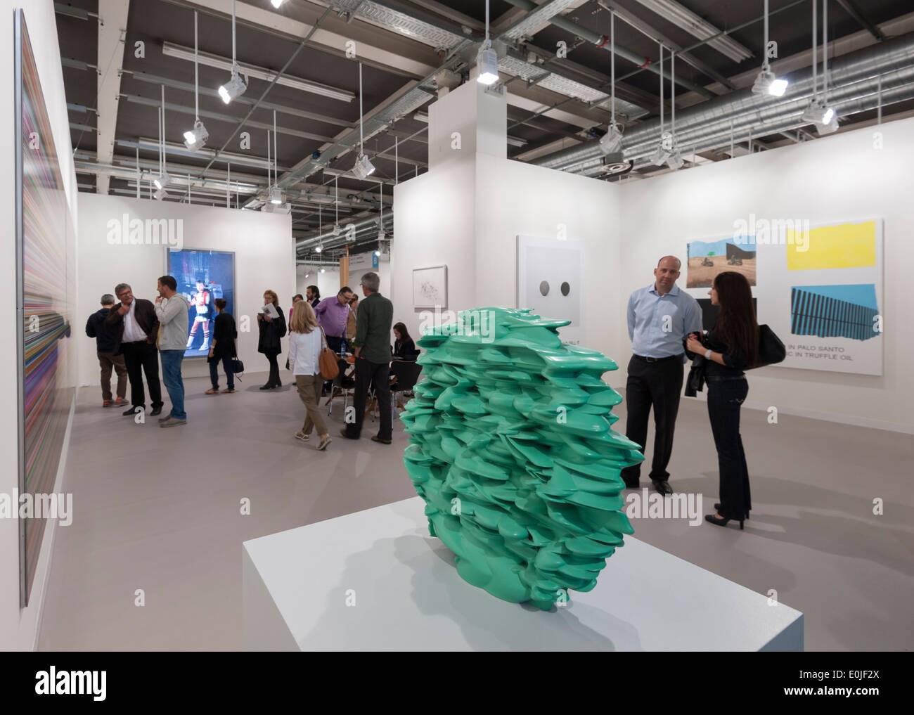 Visitors are passing by an artwork exhibited at the Art Basel 2013 in Basel, Switzerland. Stock Photo