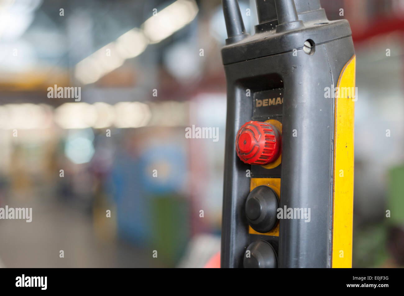 Emergency Stop button on an industrial machine at a repair shop Stock Photo