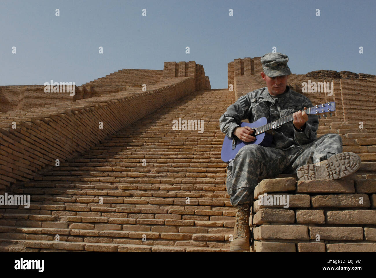 Sgt. Edward Kane, infantryman from Portland Ore., with 2/162 IN, 41st IBCT, Oregon National Guard, plays his new guitar March 1 Stock Photo