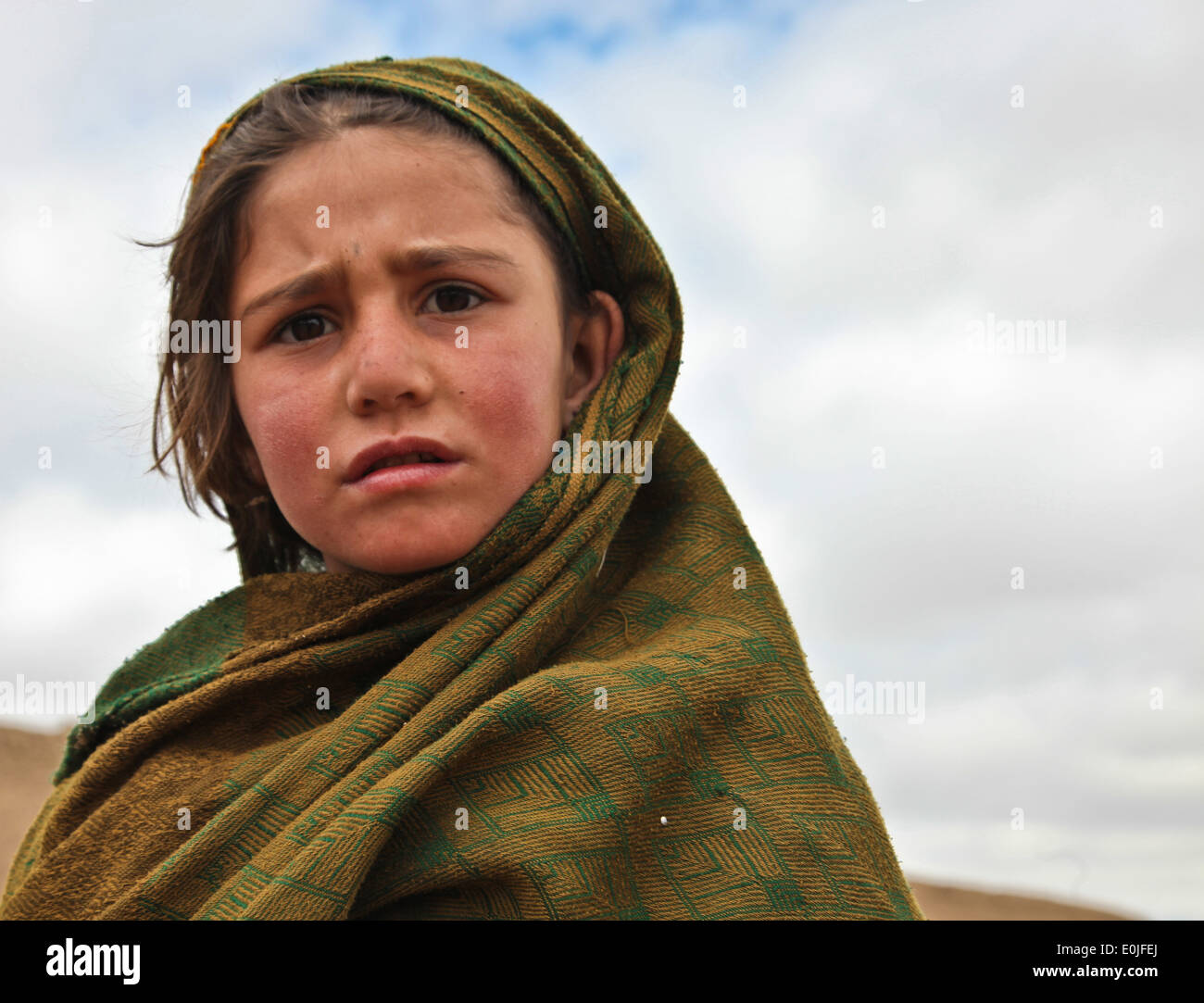 A local Afghan girl plays outside of the Medical Seminar tent in Qarah Bagh district, Ghanzi Province, Afghanistan, Feb. 19. C Stock Photo